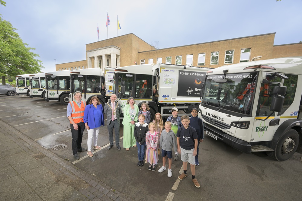 • Competition winners Edward, Alice,Ella, Jake, Joshy, Ava, Dylan and Zara show off "their" bin lorries with Rugby Borough Council recycling officer Alex Becker, former Mayor Cllr Maggie O'Rourke, Mayor Cllr Simon Ward, and Cllr Alison Livesey.